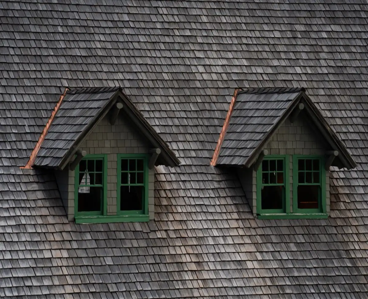 Dormers on a shingle roof in Baytown, TX, where step flashing and kickout flashing carry water past the walls